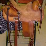 Rancher - latigo, barbed wr w channels, jockey and front basket weave, floral, rough-out seat and stirrup lthrs, dark straight-back, door handles on cantle