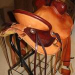 Rancher - latigo, dark straight-back, 2tone, floral, leathers out, 2 in stirrups, barbed wire w channels, corner bskt wv