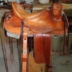 Rancher - straight-back, latigo, leathers out, corner basket wv, oak leaves, back cinch, floral conchos