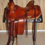 Rancher - barbed wire w channels, corner bskt wv, dark straight-back, leathers out, latigo, floral, bell stirrups