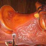 Trainer - oak leaves, floral, cheyenne roll, latigo wrap, leathers under, back cinch (1)