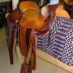 Wade - mule hide, bucking rolls, dark stirrup lthrs out, dark straight-back, 2 strand barbed wire, corner bskt wv, floral