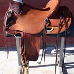 Wade - mule hide, wood post horn, dark straight-back, dark bskt wv front, rough-out seat, leathers out, full bskt wv jockey, floral, bskt wv border