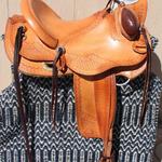 Wade - Santa Fe and s-swirl, corner basket weave, mule hide, bucking rolls, floral conchos, cheyenne roll, stirrup lthrs out, cinch keeper on side string, brass oxbows (1)