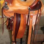 Wade - mule hide, 2 tone, tooled stirrup lthrs, corner basket wv, wood bound stirrups, cheyenne roll, floral conchos